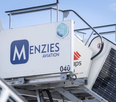 Menzies Aviation ground support equipment fitted with solar panels and sustainability branding.