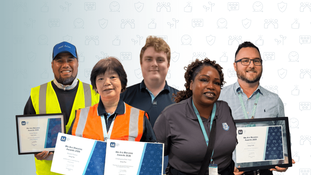 Group of Menzies Aviation employees holding “We Are Menzies Awards 2026” certificates against a neutral background.