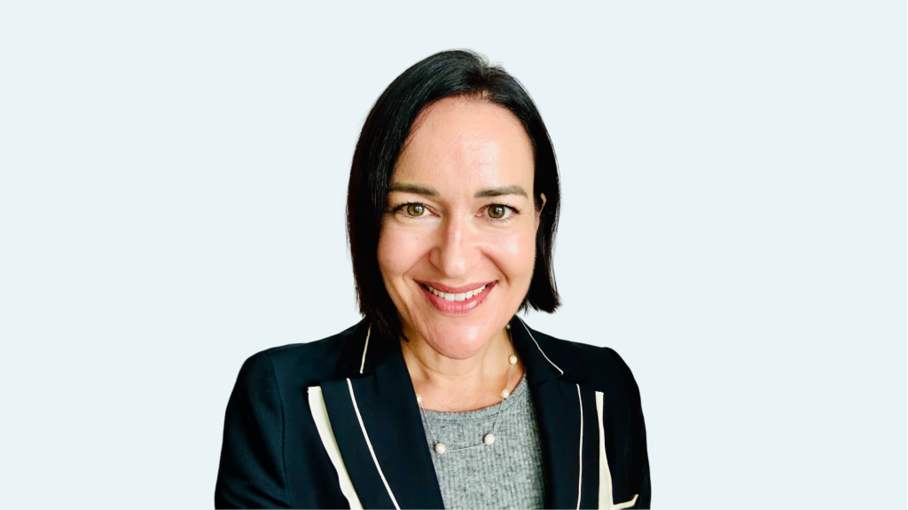 Professional headshot of a Menzies Aviation executive against a light grey background.