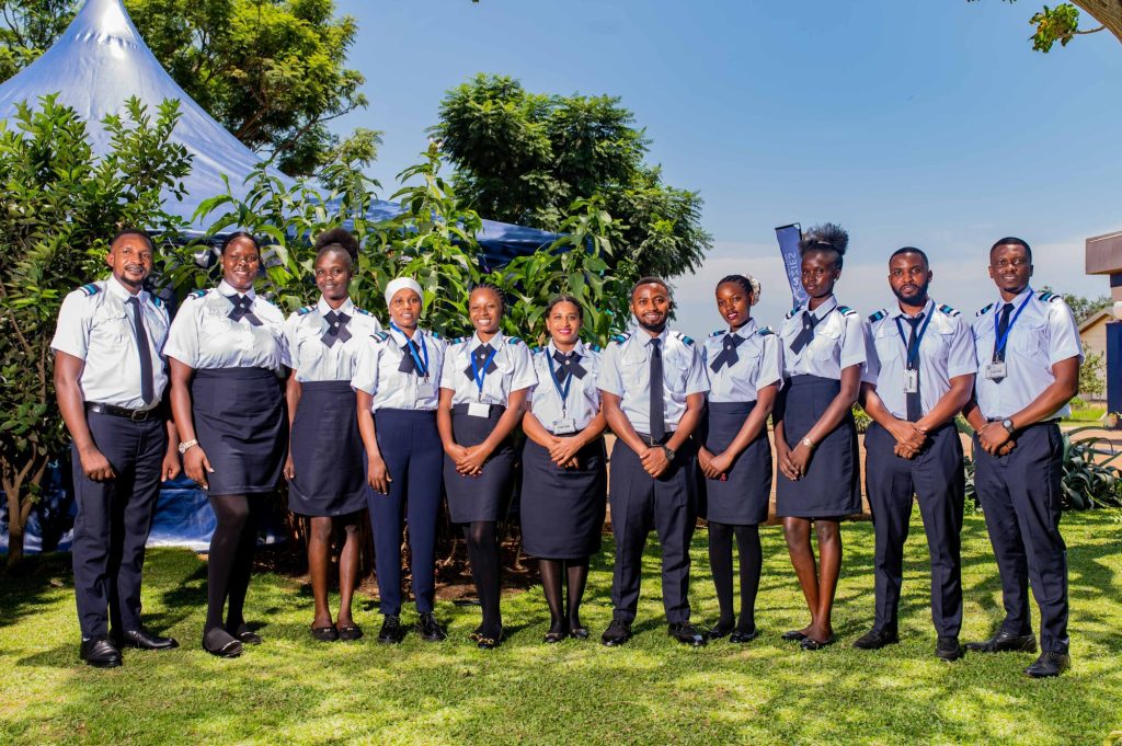 Group of aviation training school participants standing outdoors in uniform during a team photograph.