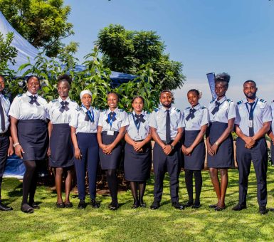 Group of aviation training school participants standing outdoors in uniform during a team photograph.