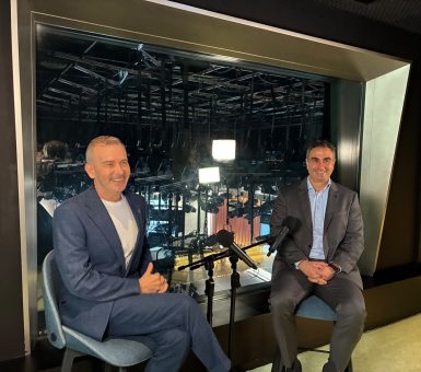 Two speakers seated with microphones during the recording of the Inside Brief podcast.