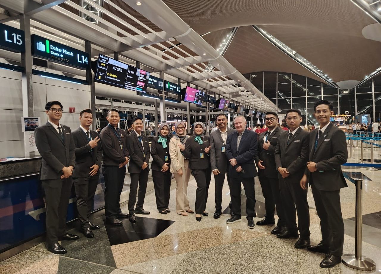 Menzies Aviation passenger services team gathered at check-in counters at Kuala Lumpur International Airport.